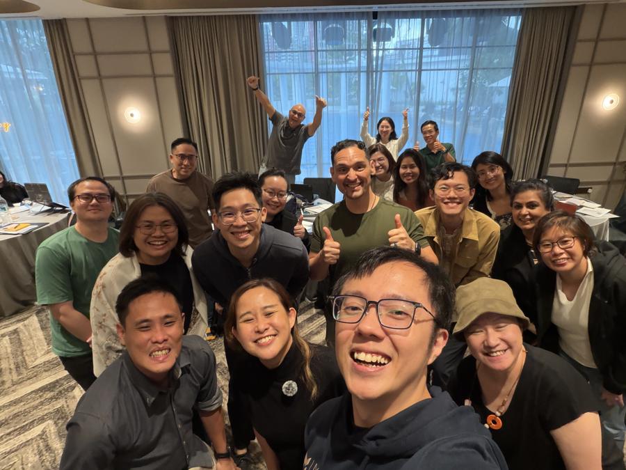 Marc's selfie with a group in a training room.