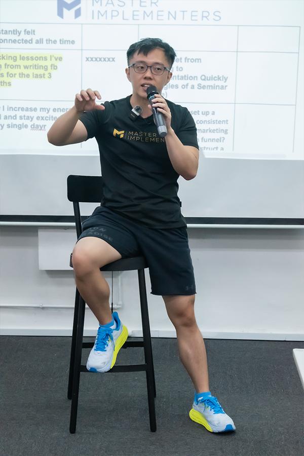 Marc seated on a stool, teaching.