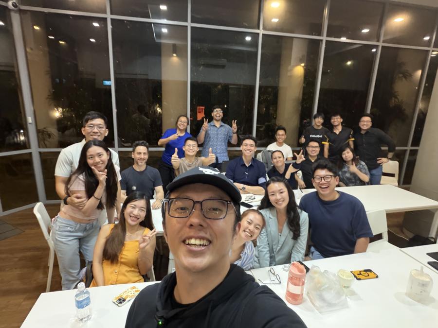 Marc's cap selfie with a group at night.